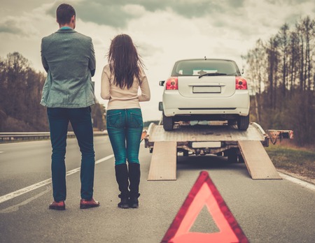 Vehicle being loaded for towing assistance