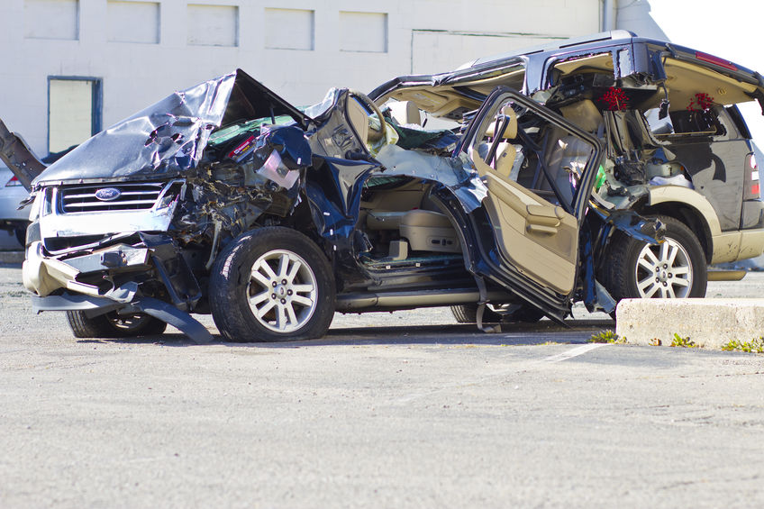 Severely damaged vehicle being evaluated after a collision