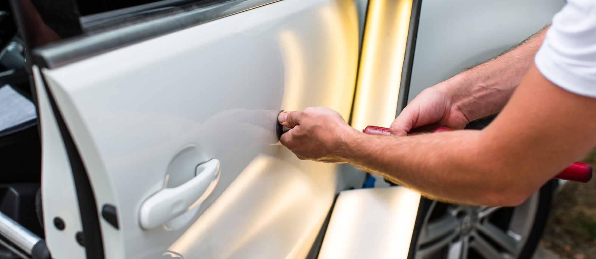 Technician performing paintless dent repair
