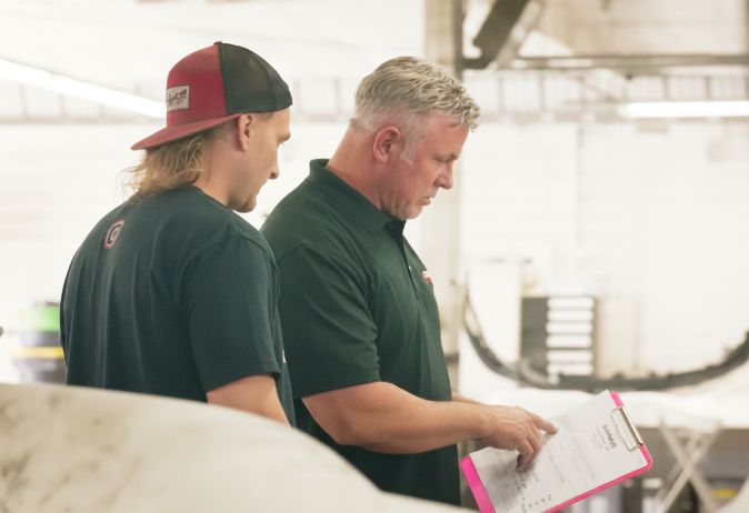 Orlando Auto Body technicians reviewing a documented repair plan together